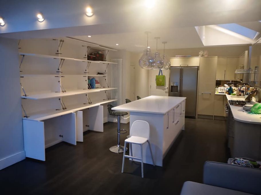 Modern kitchen with an island, bar stools, shelves, and sleek cabinetry.